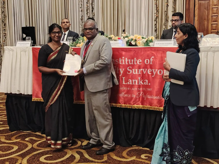 Professor Menaha Thayaparan receives recognition as a Chartered Quantity Surveyor.