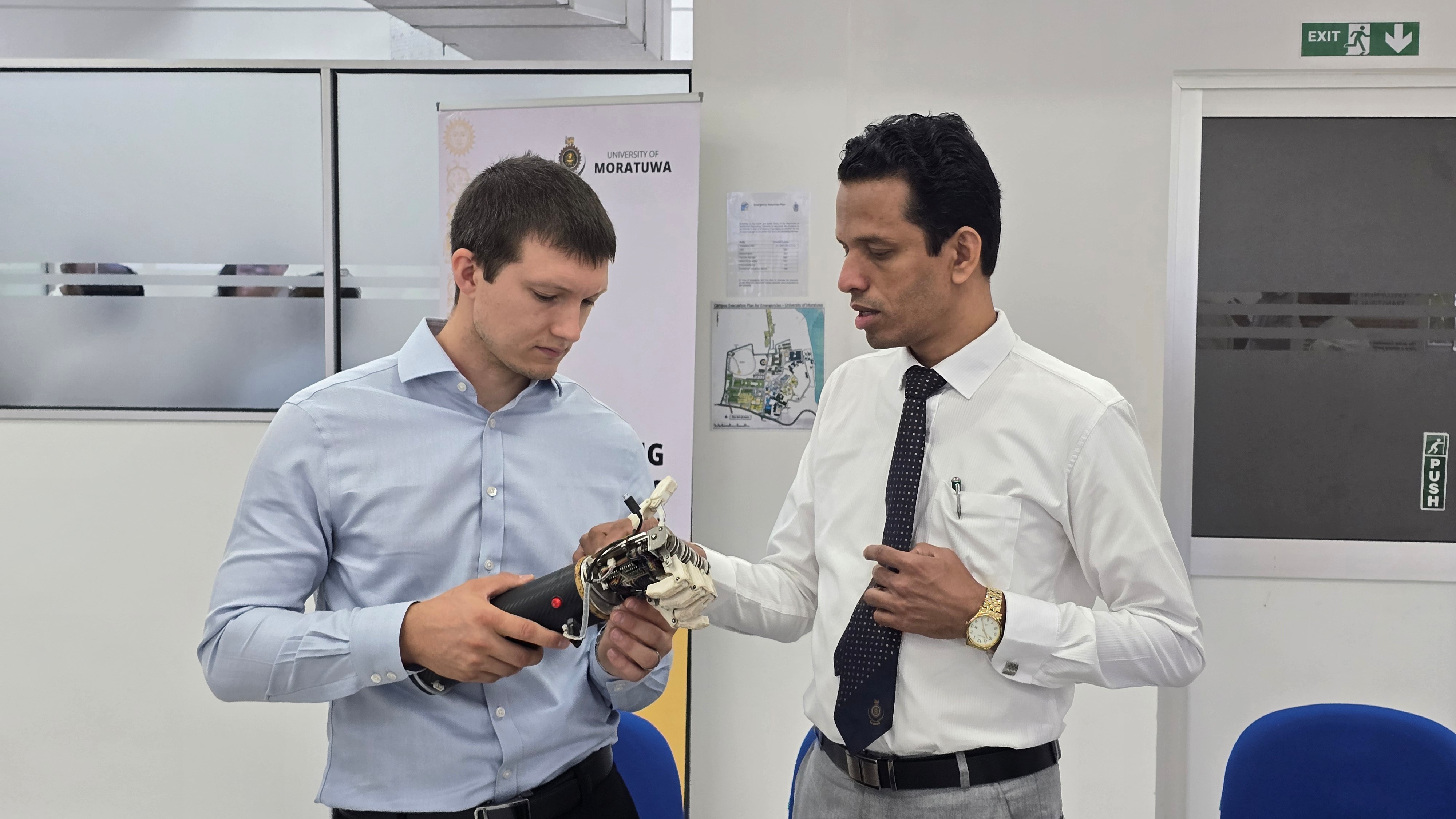A prosthetic hand prototype examined during the laboratory tour