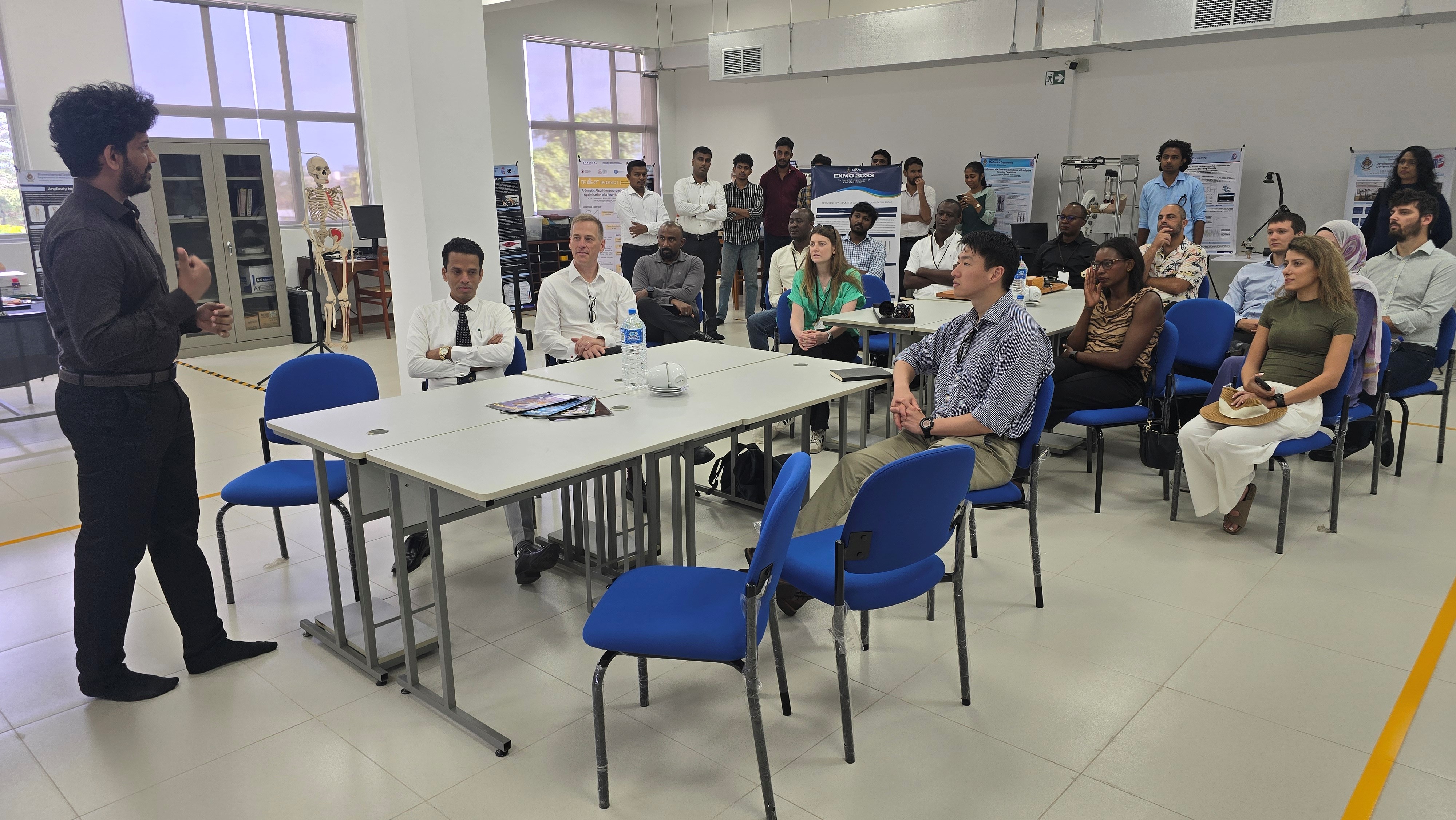 Student presenting research work to visiting delegates